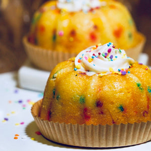 vanilla bundt cake with sprinkles and vanilla cream cheese frosting